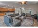 Inviting open-concept living room featuring tile flooring, a comfortable leather sectional, and a ceiling fan at 7252 E Nance St, Mesa, AZ 85207