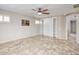 Bright main bedroom features tiled floors, a ceiling fan, and a closet with built-in shelves at 7252 E Nance St, Mesa, AZ 85207