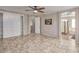 Open main bedroom with tiled floors, ceiling fan, and an ensuite bathroom for added convenience at 7252 E Nance St, Mesa, AZ 85207