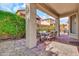 Shaded patio area perfect for entertaining with outdoor dining set and garden views at 7252 E Nance St, Mesa, AZ 85207