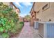Paver walkway leads to backyard patio through a small garden and past the air conditioning units at 7252 E Nance St, Mesa, AZ 85207