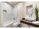 Elegant bathroom featuring a bathtub/shower combo, stylish vanity, and contemporary fixtures at 7326 E Portland St, Scottsdale, AZ 85257