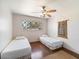 Cozy bedroom featuring two twin beds, a ceiling fan, and a bright window at 7326 E Portland St, Scottsdale, AZ 85257