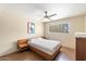 This stylish bedroom features modern decor, a ceiling fan and a large window for natural light at 7326 E Portland St, Scottsdale, AZ 85257