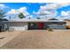 Charming single-story home with a gray exterior, red door, and well-maintained desert landscaping at 7326 E Portland St, Scottsdale, AZ 85257