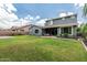 Expansive backyard with lush green lawn and a covered patio, perfect for outdoor entertaining at 7528 E Peralta Ave, Mesa, AZ 85212