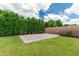 Backyard featuring a gravel area with brick borders, and a tall privacy hedge at 7528 E Peralta Ave, Mesa, AZ 85212