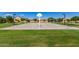 Community park with basketball court surrounded by well-manicured green grass, perfect for recreation at 7528 E Peralta Ave, Mesa, AZ 85212