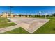 Full basketball court with well-maintained landscaping and lighting in a sunny community park setting at 7528 E Peralta Ave, Mesa, AZ 85212