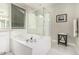 Bright bathroom features a soaking tub, glass shower, and white marble floors, with a neutral color palette at 7528 E Peralta Ave, Mesa, AZ 85212