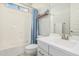 Bright bathroom featuring a white vanity and a shower-tub combination with a blue shower curtain at 7528 E Peralta Ave, Mesa, AZ 85212