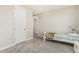 Neutral bedroom with a white frame bed, carpet flooring, and access to the hallway and other rooms at 7528 E Peralta Ave, Mesa, AZ 85212