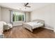 Bright bedroom with hardwood floors, a large window, and comfortable furnishings at 7528 E Peralta Ave, Mesa, AZ 85212