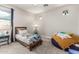 Comfortable bedroom featuring a single bed, bedside table, accent chair and carpet flooring, creating a cozy space at 7528 E Peralta Ave, Mesa, AZ 85212