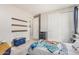 Cozy bedroom with carpet, three floating shelves, closet with sliding doors, and Harry Potter themed bedding at 7528 E Peralta Ave, Mesa, AZ 85212