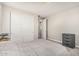 Cozy bedroom featuring carpet, a bed with neutral bedding, and closet with sliding doors, with a neutral color palette at 7528 E Peralta Ave, Mesa, AZ 85212