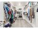 Walk-in closet with built-in shelving and racks, offering ample storage space for clothes and accessories at 7528 E Peralta Ave, Mesa, AZ 85212