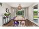Bright dining room with a wooden table, colorful chairs, and an outdoor view at 7528 E Peralta Ave, Mesa, AZ 85212