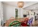 Open concept dining area with a large wooden table and an adjacent kitchen and living area at 7528 E Peralta Ave, Mesa, AZ 85212