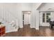 Elegant foyer featuring hardwood floors, a staircase, and a view into the home at 7528 E Peralta Ave, Mesa, AZ 85212