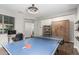 Well-lit game room featuring a ping pong table, desk, and modern furnishings at 7528 E Peralta Ave, Mesa, AZ 85212