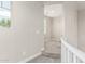 Hallway featuring carpet flooring and white trim that transitions to a room with carpet and light-filtering blinds at 7528 E Peralta Ave, Mesa, AZ 85212