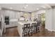 Open kitchen with a center island, modern appliances, and seamless flow into the dining and living areas at 7528 E Peralta Ave, Mesa, AZ 85212