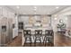 Bright kitchen with gray cabinetry, stainless steel appliances, and center island with bar stool seating at 7528 E Peralta Ave, Mesa, AZ 85212