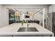 This kitchen features modern appliances, quartz countertops, and flows nicely into the living room at 7528 E Peralta Ave, Mesa, AZ 85212