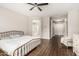 A brightly lit primary bedroom showcases hardwood floors and easy access to a primary bathroom at 7528 E Peralta Ave, Mesa, AZ 85212
