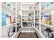 Walk-in pantry with floor-to-ceiling shelving and ample storage space for kitchen supplies and snacks at 7528 E Peralta Ave, Mesa, AZ 85212