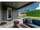 Cozy patio with comfortable outdoor furniture and a lush, green lawn, perfect for relaxing and entertaining at 7528 E Peralta Ave, Mesa, AZ 85212