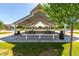 Community picnic pavilion with covered seating and a grill in a park setting at 7528 E Peralta Ave, Mesa, AZ 85212