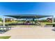 Neighborhood park with a shaded playground area offering various play equipment at 7528 E Peralta Ave, Mesa, AZ 85212