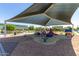 Neighborhood playground features a covered play structure and ample seating with picnic tables at 7528 E Peralta Ave, Mesa, AZ 85212