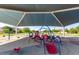 Shaded community playground featuring colorful play structures, providing a fun and safe environment for  at 7528 E Peralta Ave, Mesa, AZ 85212