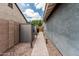 A paved walkway between homes with outdoor storage and landscaped gravel at 7528 E Peralta Ave, Mesa, AZ 85212