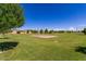 Picturesque community park offering a sand volleyball court, surrounded by lush green grass and residential homes at 7528 E Peralta Ave, Mesa, AZ 85212
