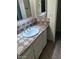 Bathroom vanity with cream color and cream and brown tiled counter at 8055 E Thomas Rd # H103, Scottsdale, AZ 85251