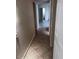 Hallway featuring neutral walls, tile floors and a door leading to a bathroom at 8055 E Thomas Rd # H103, Scottsdale, AZ 85251