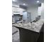 Kitchen featuring white cabinets, white appliances, and a tile countertop island at 8055 E Thomas Rd # H103, Scottsdale, AZ 85251