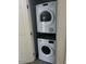 A tidy laundry closet features a stacked, white Bosch washer and dryer for space-saving convenience at 8055 E Thomas Rd # H103, Scottsdale, AZ 85251