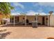 Lovely backyard featuring covered patio area and mature trees providing ample shade at 8302 E Dutchman Dr, Mesa, AZ 85208