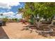 Spacious backyard featuring mature landscaping and shade trees, creating a private and serene outdoor retreat at 8302 E Dutchman Dr, Mesa, AZ 85208