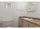 Bathroom with toilet, sink, vanity, and mirror at 8302 E Dutchman Dr, Mesa, AZ 85208