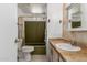 Bathroom with toilet, sink, vanity, shower, and mirror at 8302 E Dutchman Dr, Mesa, AZ 85208