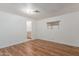 Comfortable bedroom with laminate flooring, neutral walls, and natural light at 8302 E Dutchman Dr, Mesa, AZ 85208