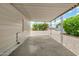 Covered back patio overlooking a serene backyard landscape featuring mature trees and shrubs at 8330 E Pueblo Ave, Mesa, AZ 85208