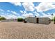 Expansive backyard with gravel landscaping, surrounding wall and neighboring trees at 8330 E Pueblo Ave, Mesa, AZ 85208