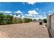 Backyard featuring easy-care gravel landscaping, mature trees, and a serene setting at 8330 E Pueblo Ave, Mesa, AZ 85208